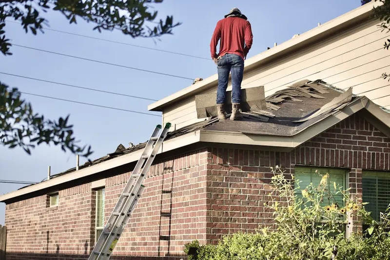 Professional roofer working on a residential roof in Freehold